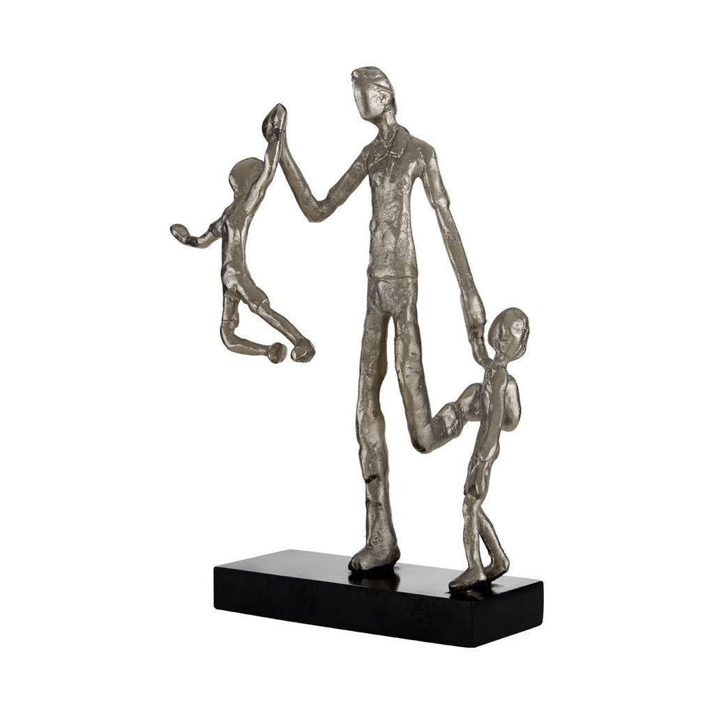 Silver abstract sculpture of a figure with two children on a white background