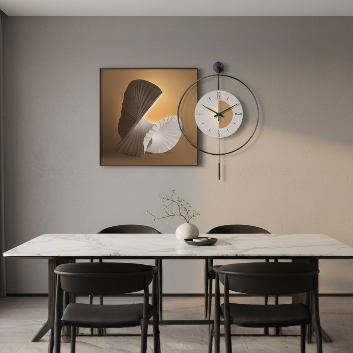 A modern dining room scene featuring a square abstract wall art print with a fan and shell motif in beige, brown, and white tones, displayed above a white marble dining table with black chairs. A minimalist black metal ring wall clock hangs to the right of the artwork on a warm gray wall.