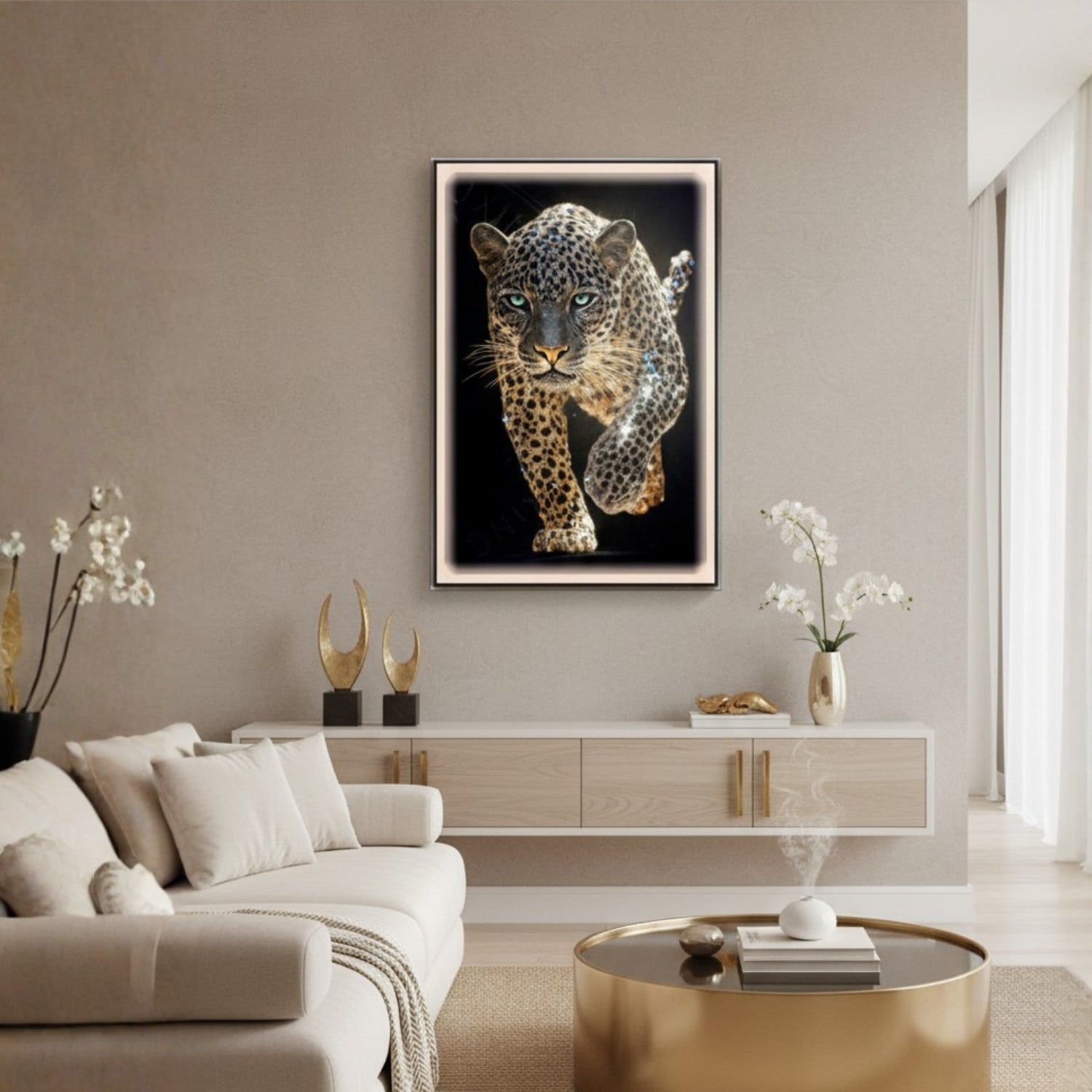 A framed wall art print of a leopard on a black background, displayed above a modern light wood console in a beige living room with a sofa, decorative vases, and a gold coffee table.