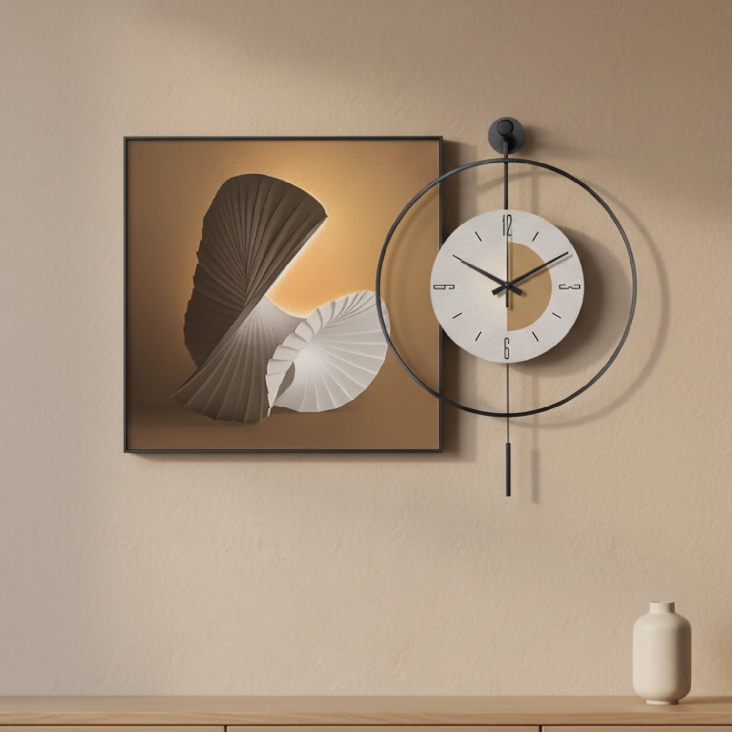 Modern wall decor set featuring a square framed abstract art print and a minimalist black metal ring wall clock with a white face, mounted on a beige wall above a wooden shelf with a small vase.