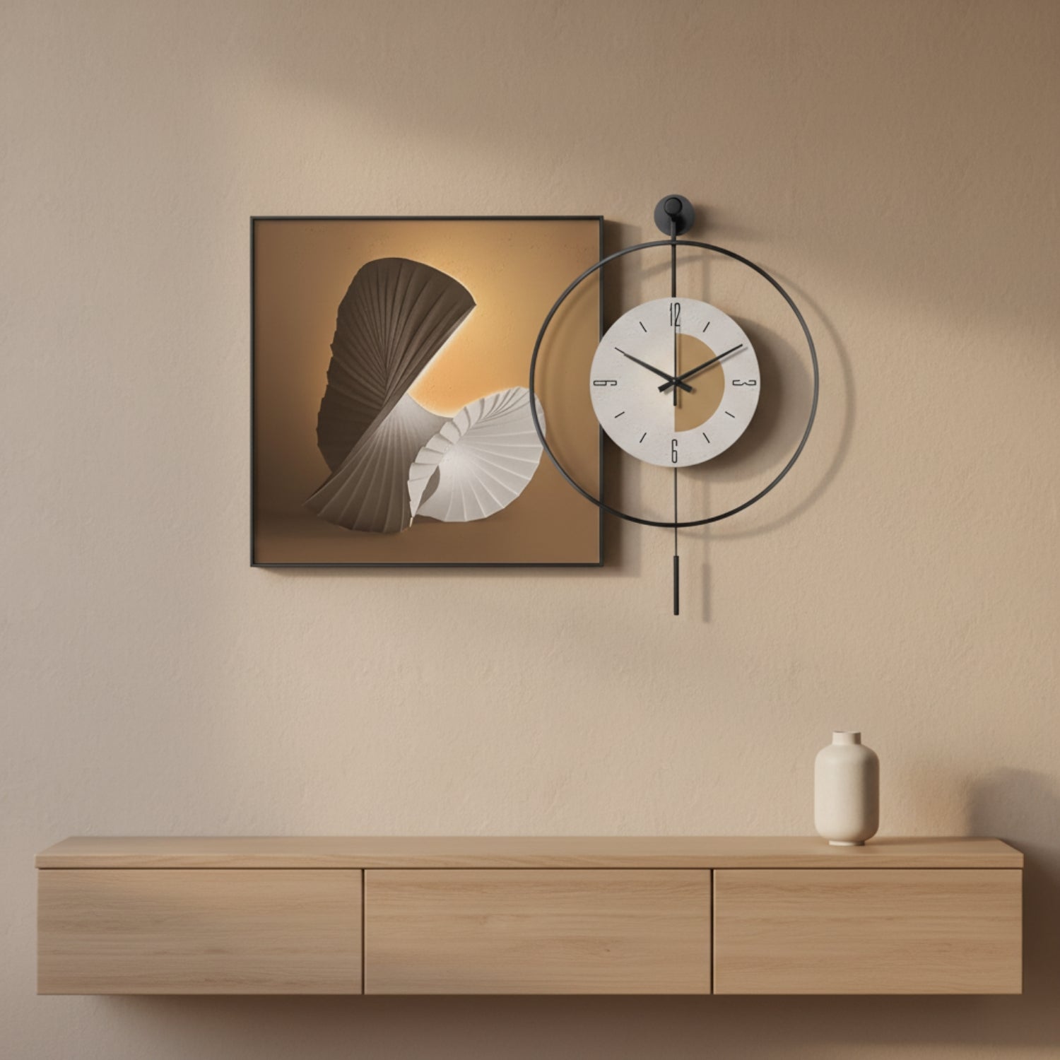 A modern wall-mounted clock with a circular black frame and white face sits beside a framed abstract art print above a light wood console table with a small vase.