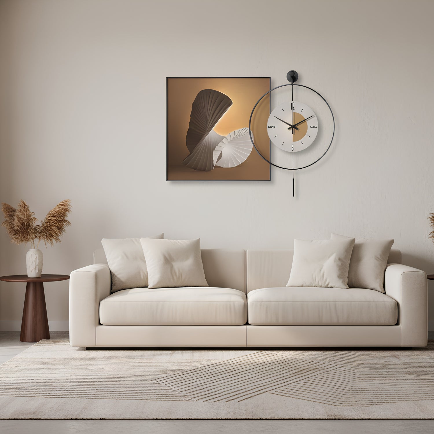 A modern living room scene featuring a cream-colored sofa, a small wooden side table with dried pampas grass, and a minimalist wall art piece depicting a fan and shell on a warm gradient background. A black metal ring clock is mounted on the wall above the sofa.