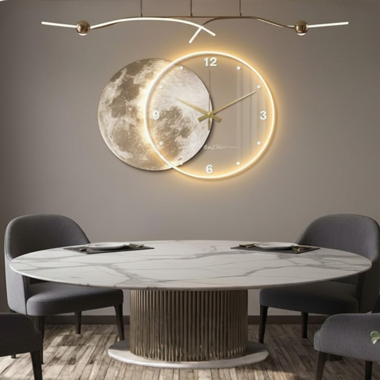 A modern wall clock featuring a moon design and glowing circular LED border, mounted on a gray wall above a dining table with chairs.