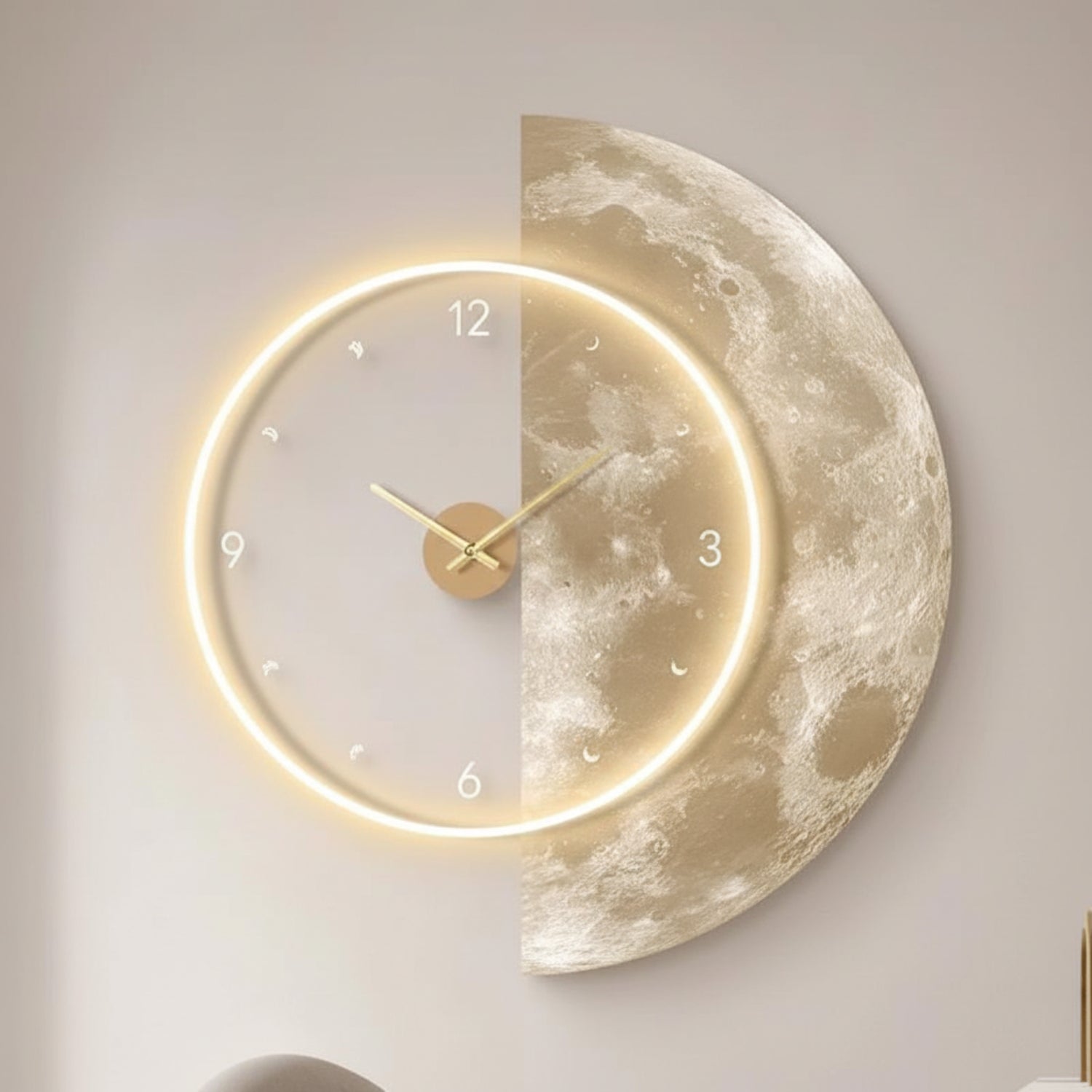 A crescent moon wall clock mounted on a light beige wall. The left half of the moon features a glowing warm white LED ring with gold hands and small white Arabic numerals, while the right half shows a realistic textured moon surface in warm beige and cream tones.