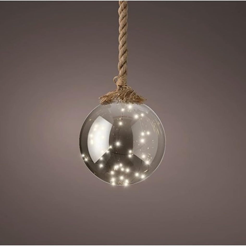 A clear glass globe pendant light hanging from a thick natural jute rope, with warm white LED fairy lights glowing inside, set against a dark brown gradient background.