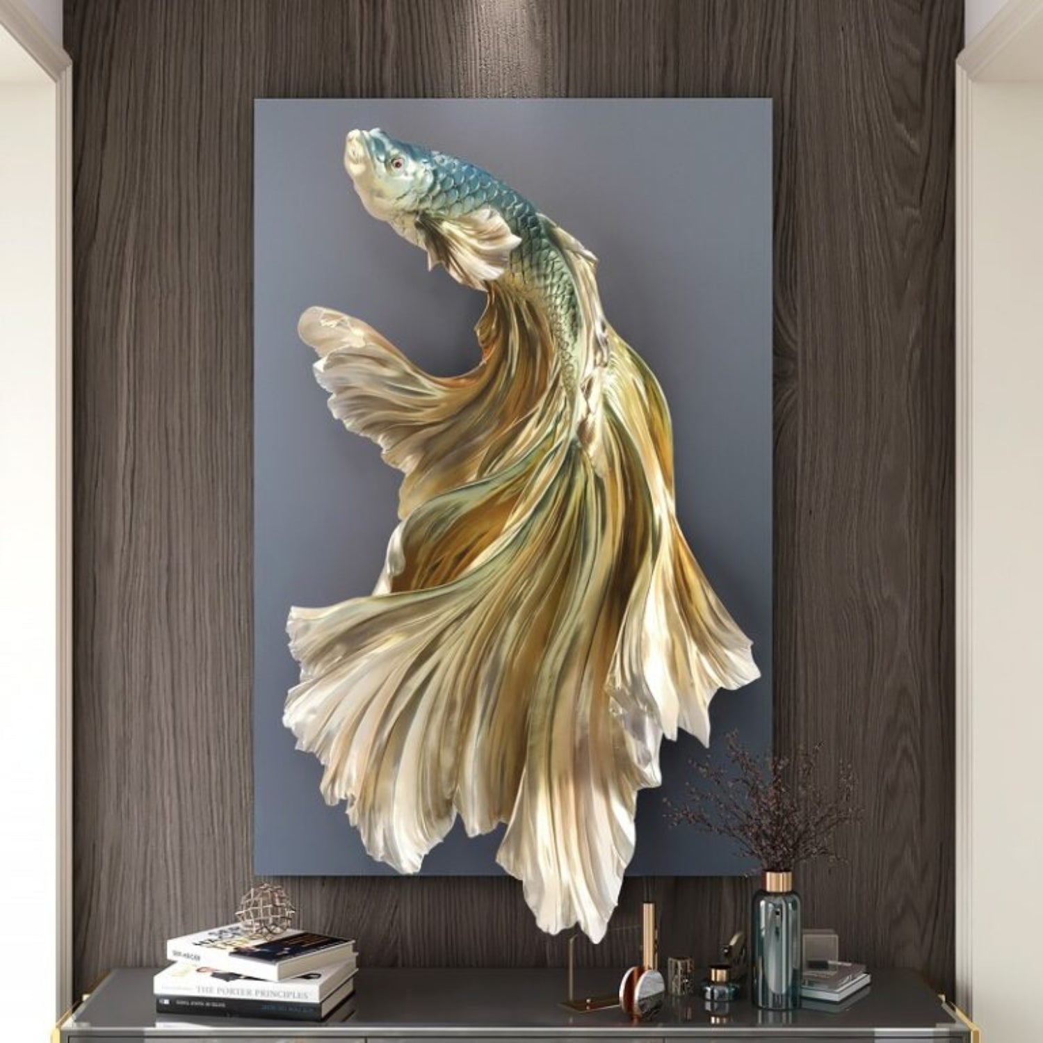 Large vertical wall art featuring a stylized gold and teal fish with flowing fins, displayed above a console table in a modern interior setting.