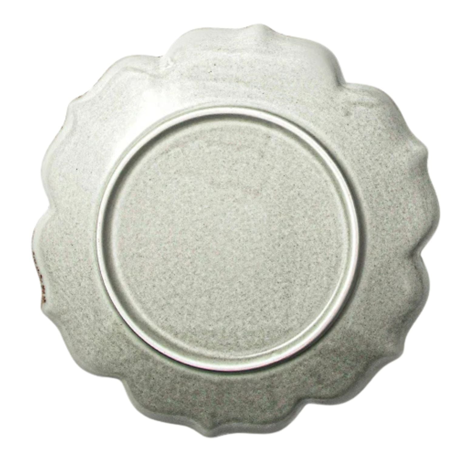 A round, scalloped-edge ceramic plate in a speckled light gray glaze, photographed from directly above on a white background.