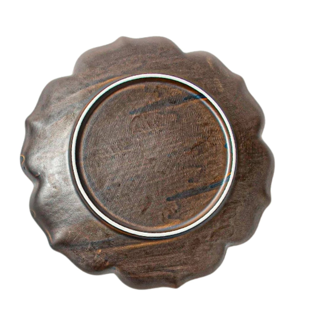 A round wooden spoon or scoop with a scalloped, wavy edge and a smooth, polished dark brown center, shown from a top-down perspective on a white background.
