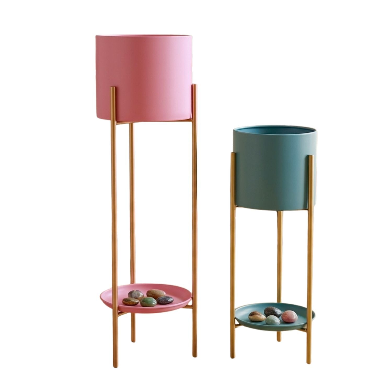 Two modern two-tier plant stands on a white background. One stand features a pink cylindrical planter and matching pink saucer, while the other features a teal planter and matching teal saucer, both supported by slim gold metal stands.