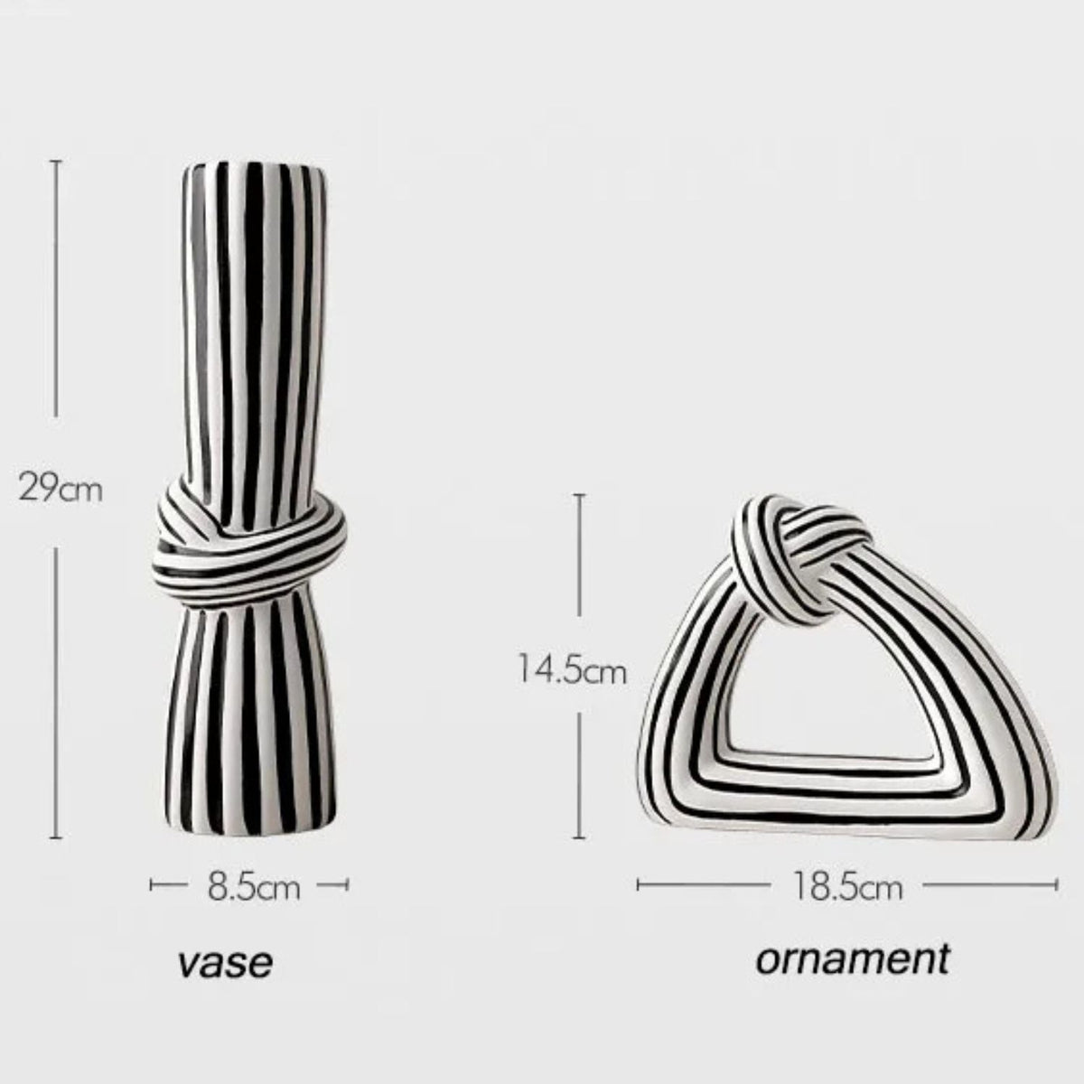 Two black and white striped decorative home accessories shown with dimension labels: a cylindrical vase tied at the middle (29 cm tall, 8.5 cm wide) and a triangular knot-shaped ornament (14.