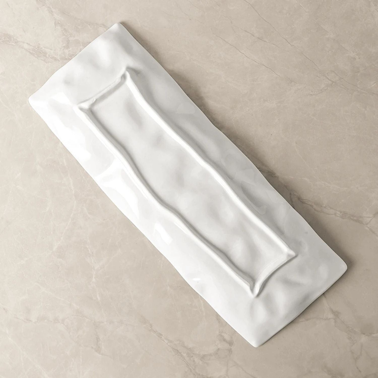 Rectangular white ceramic tray on a beige surface