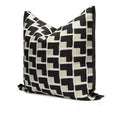 Square black and cream geometric cushion with a bold repeating pattern and black border
