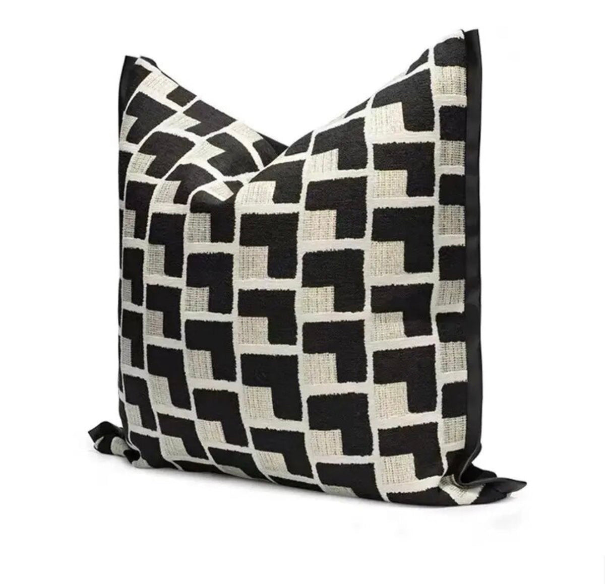 Square black and cream geometric cushion with a bold repeating pattern and black border