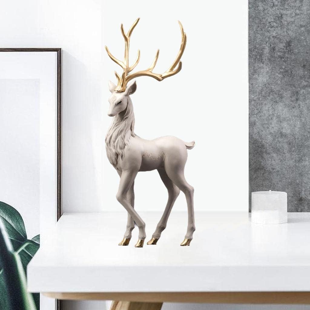 White and gold standing stag deer sculpture 55cm styled on white console table in modern neutral interior with plant