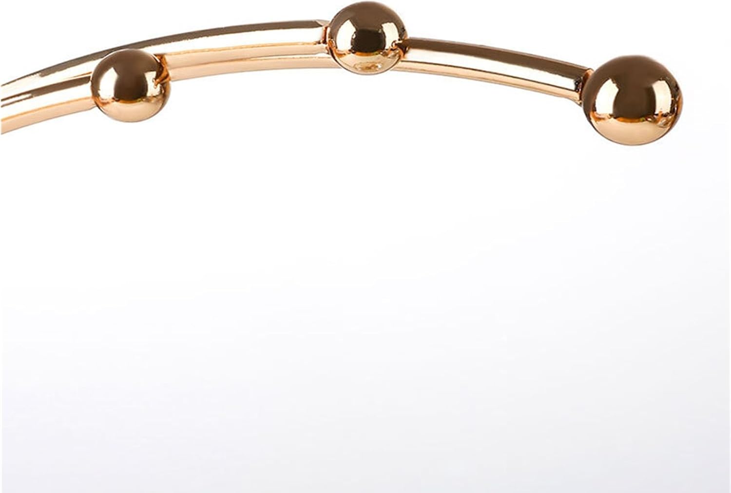 Close up of three gold ball finials on the crescent arc