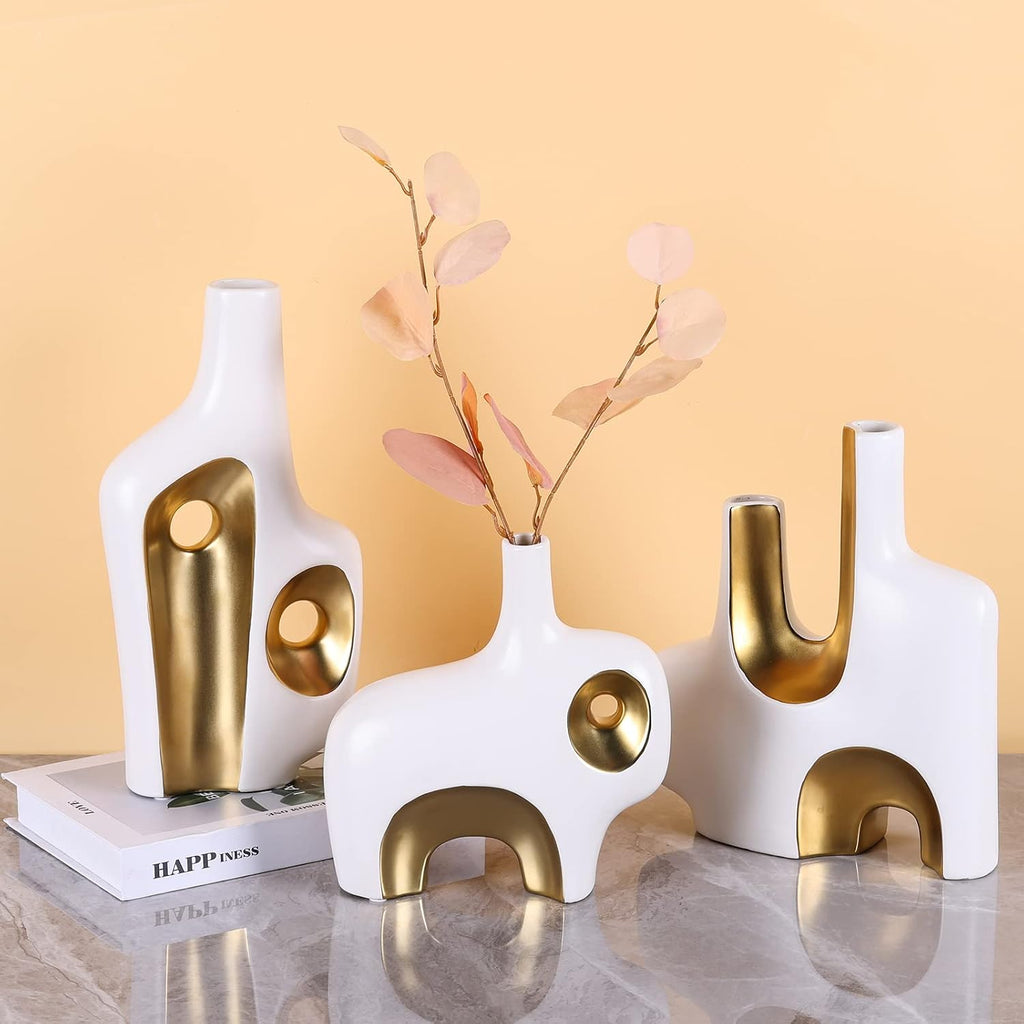 Abstract art vase set of 3 on marble surface with warm background