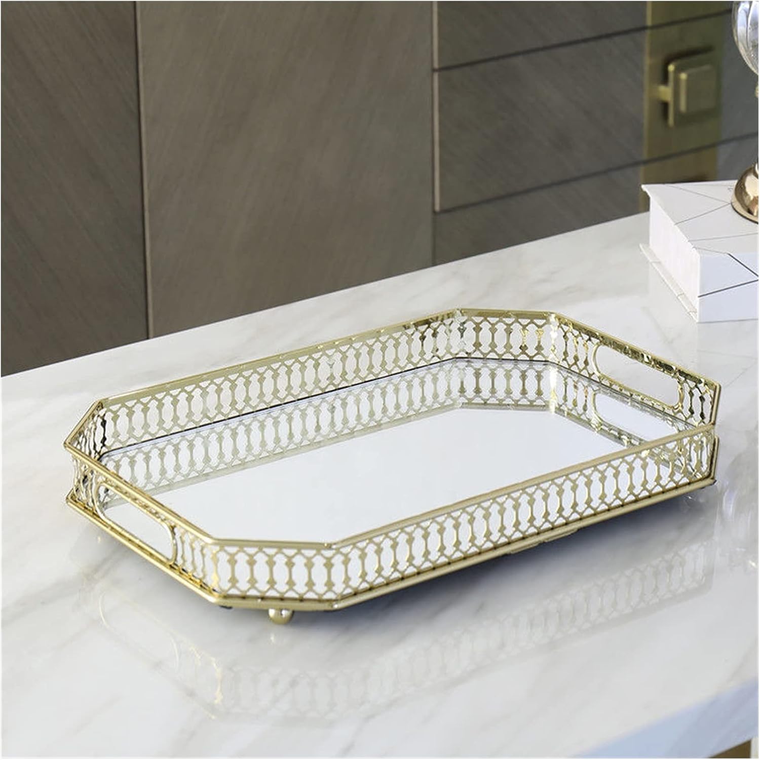 Gold filigree octagonal mirror tray empty product shot on marble surface