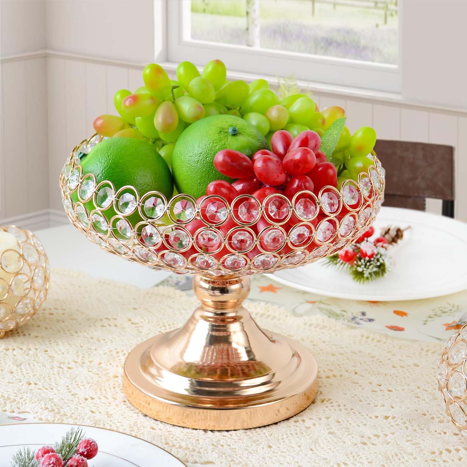 Gold crystal pedestal fruit bowl on marble surface in moody setting