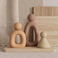 Abstract family sculpture set of 3 on wooden tray with linen background