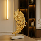Gold peacock feather sculpture on marble base styled in luxury living room