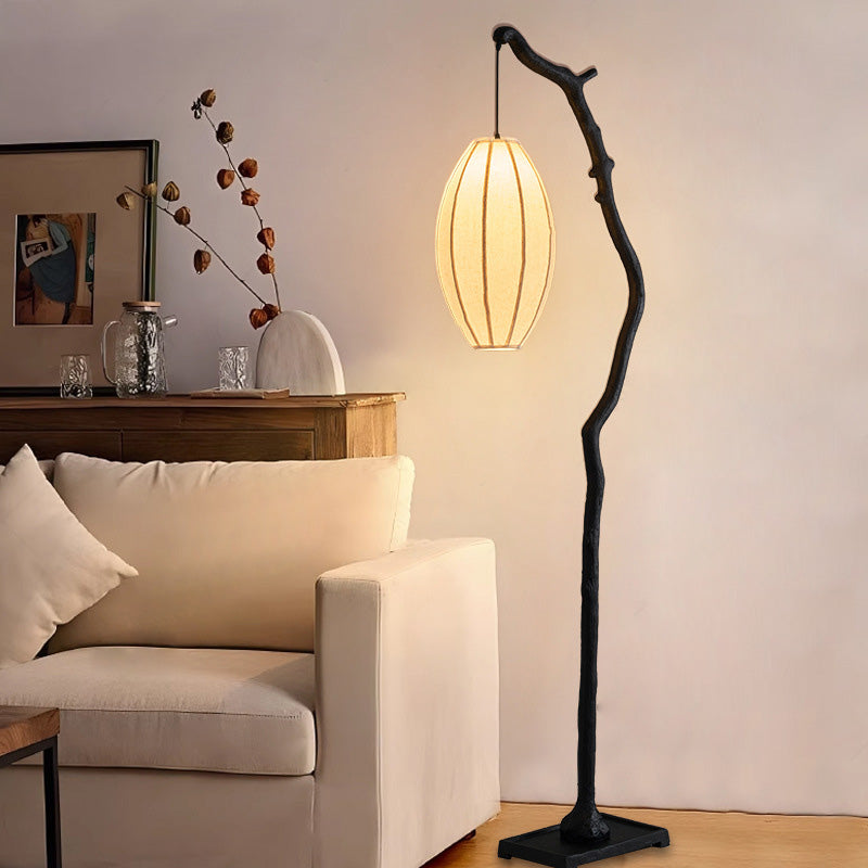 Branch Lantern Floor Lamp in warm living room beside sofa