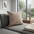 Beige chain-pattern cushion styled on a grey sofa