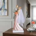 Pink wedding couple figurine styled on wooden console table in luxury neutral living room with abstract wall art