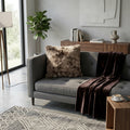 Brown and beige shaggy cushion styled on a grey sofa