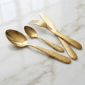 Gold Hammered Cutlery Set 24 Piece – flat lay on marble showing all four pieces