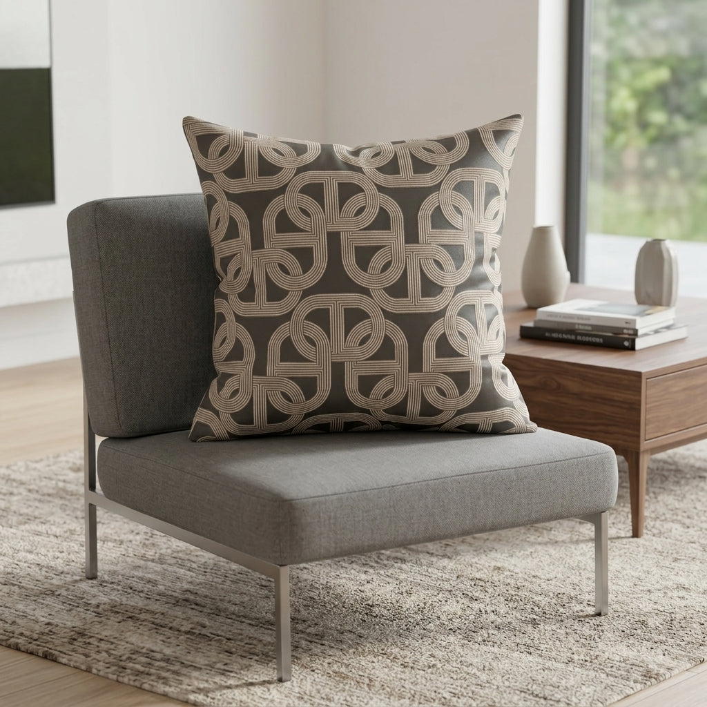 Grey cushion with cream-toned chain link pattern styled on a grey armchair