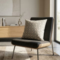 Maze grey and cream geometric cushion styled on a dark armchair