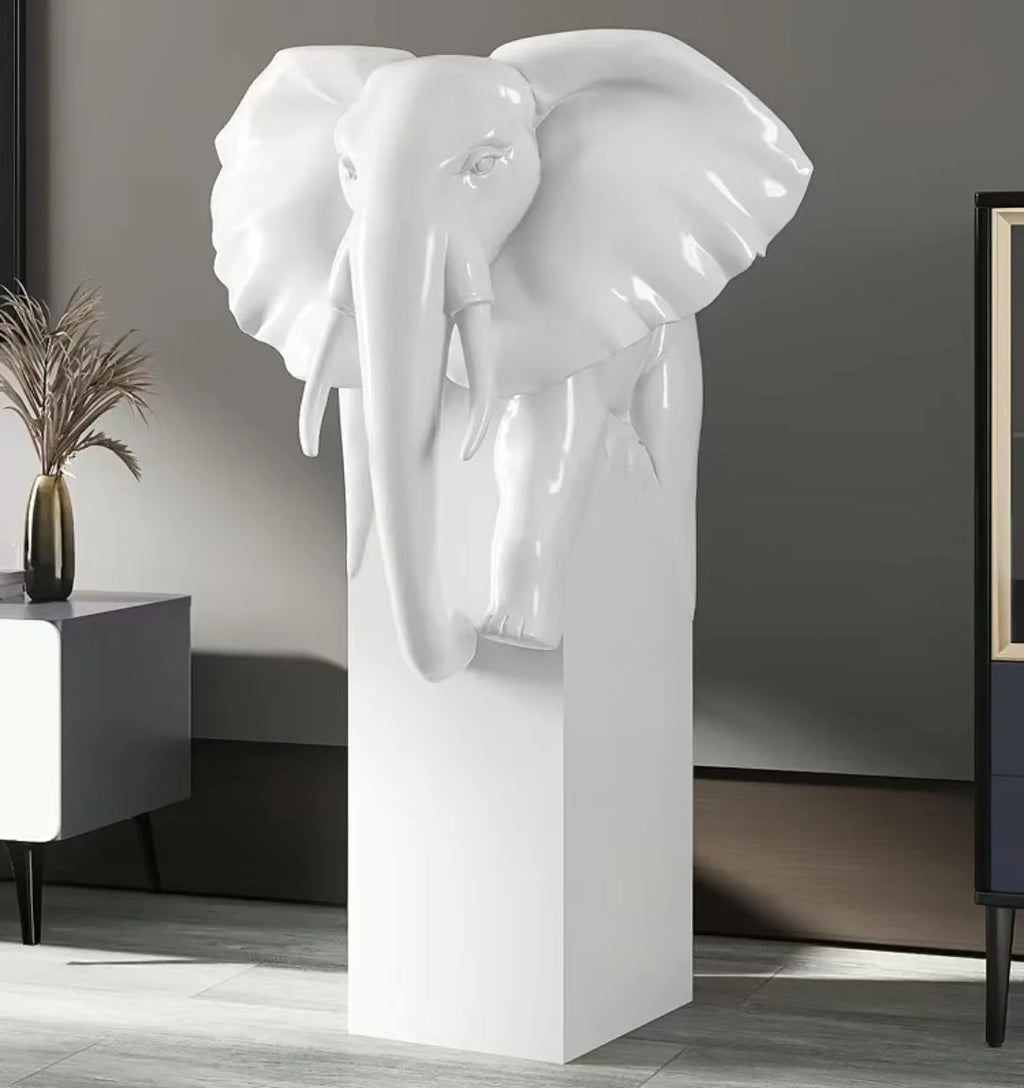 White elephant head sculpture on pedestal in contemporary interior