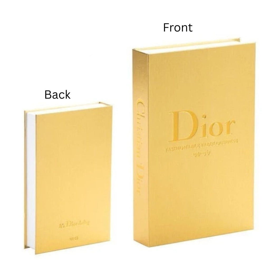 A gold-colored Christian Dior hardcover notebook shown from both front and back angles on a plain white background.