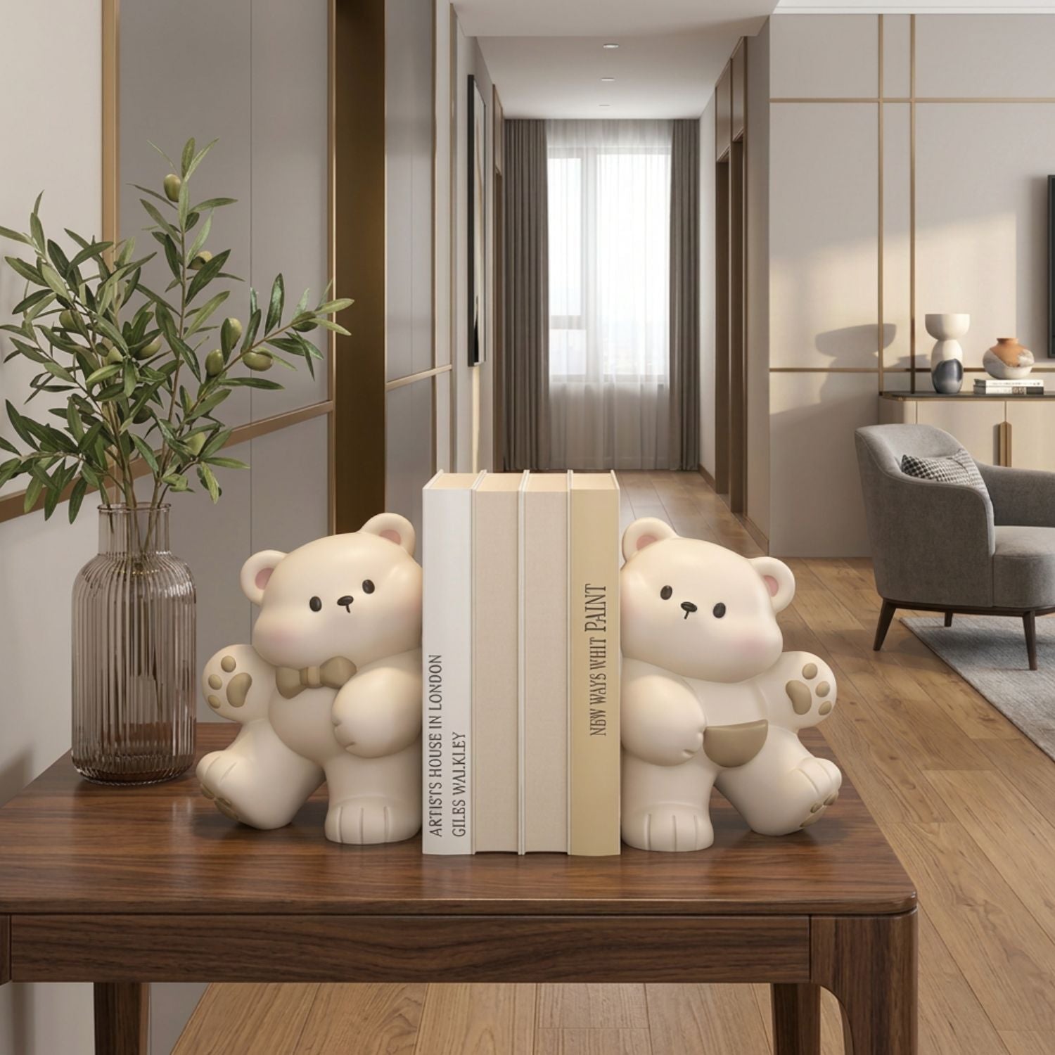 Two cream-colored bear-shaped bookends holding a set of three books on a dark wooden table in a modern, warm-toned living room setting.