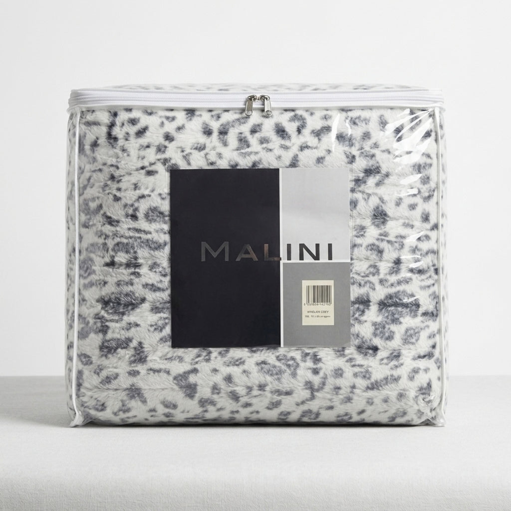 A packaged bedding set by Malini, featuring a white and gray leopard print pattern, sealed in clear plastic with a prominent black and silver brand label on the front.
