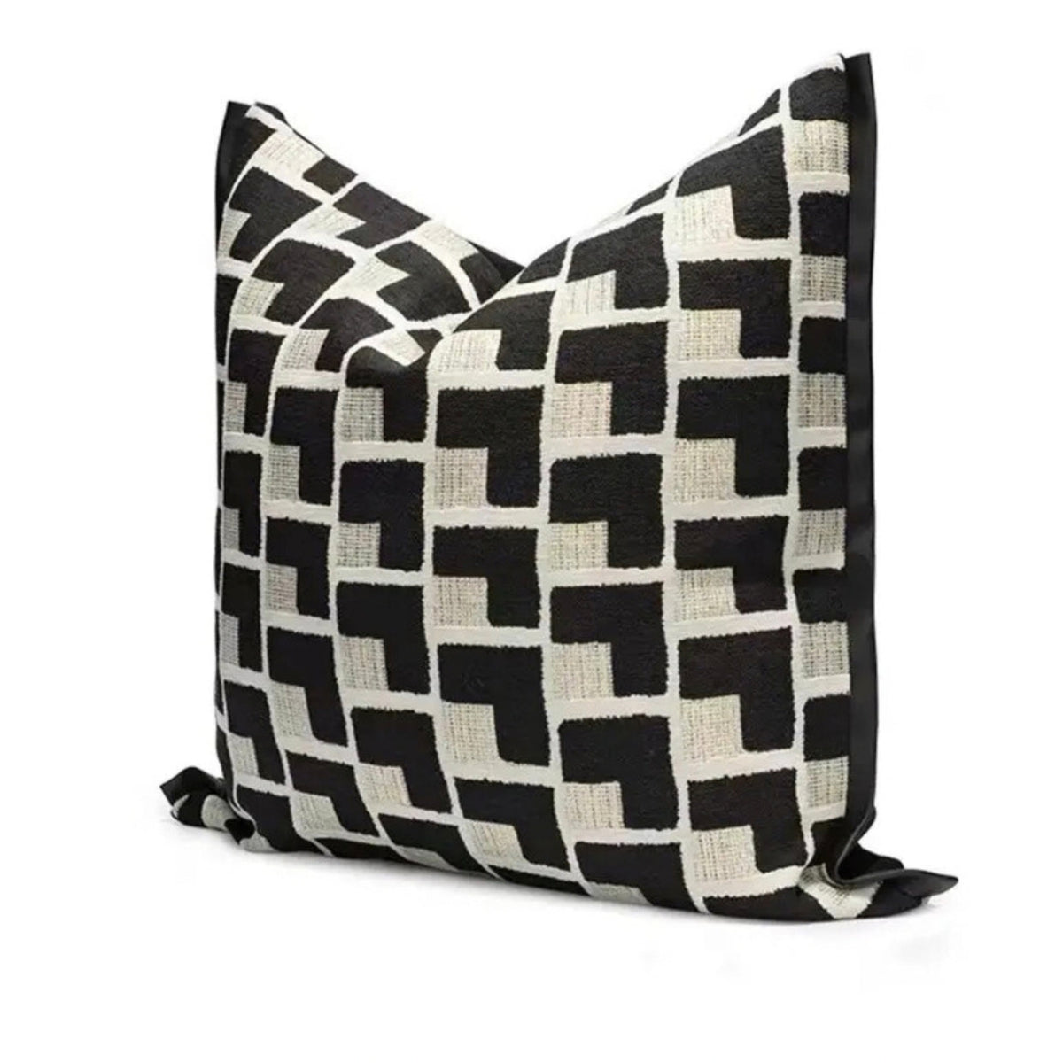 A square throw pillow featuring a bold black and off-white geometric pattern, photographed on a clean white background.