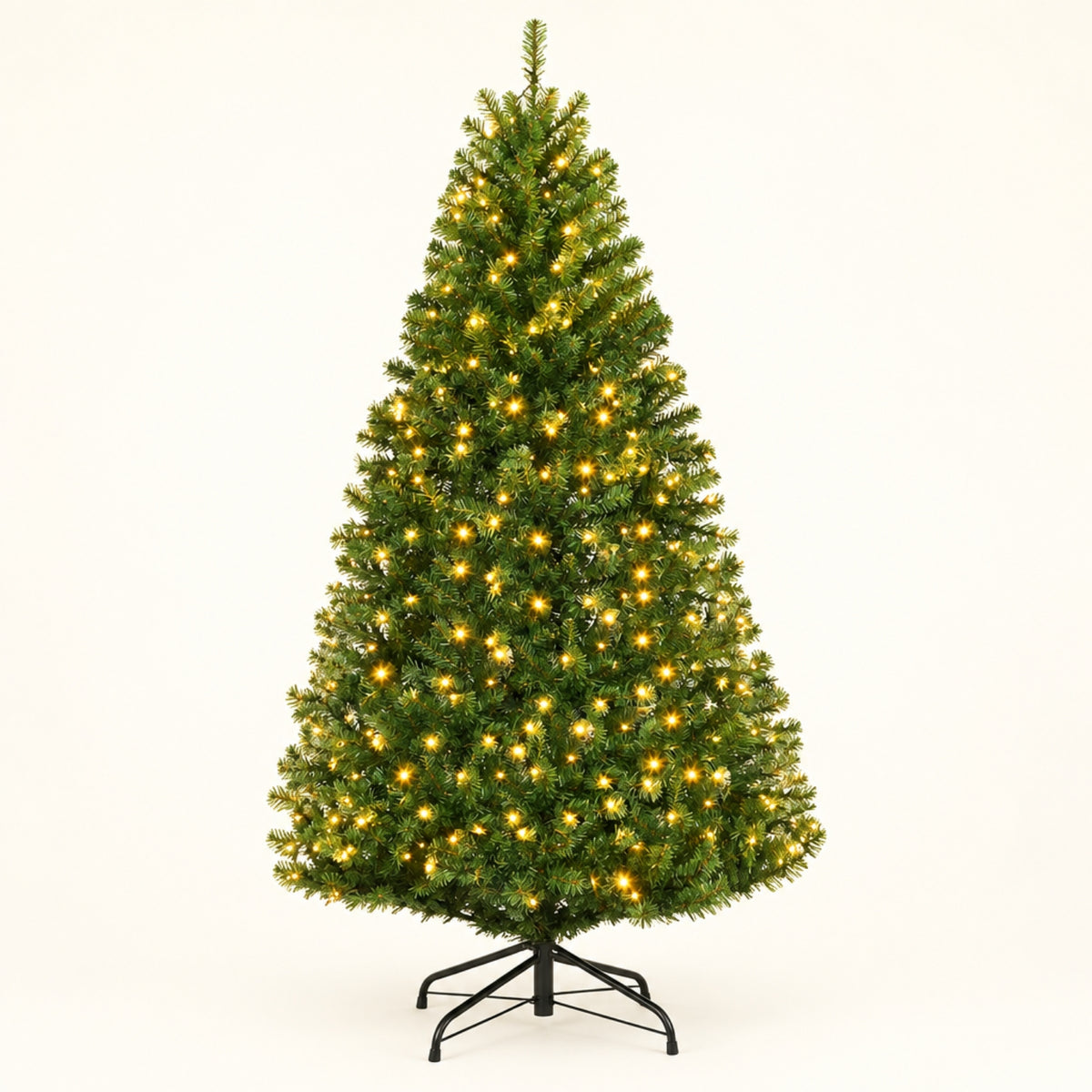 A pre-lit artificial Christmas tree with warm white lights, standing on a black metal stand against a plain white background.