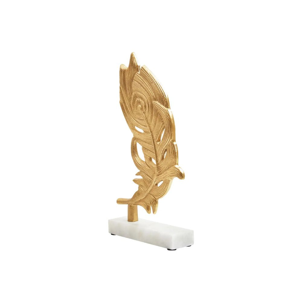 Gold peacock feather sculpture on marble base, angled view showing detail