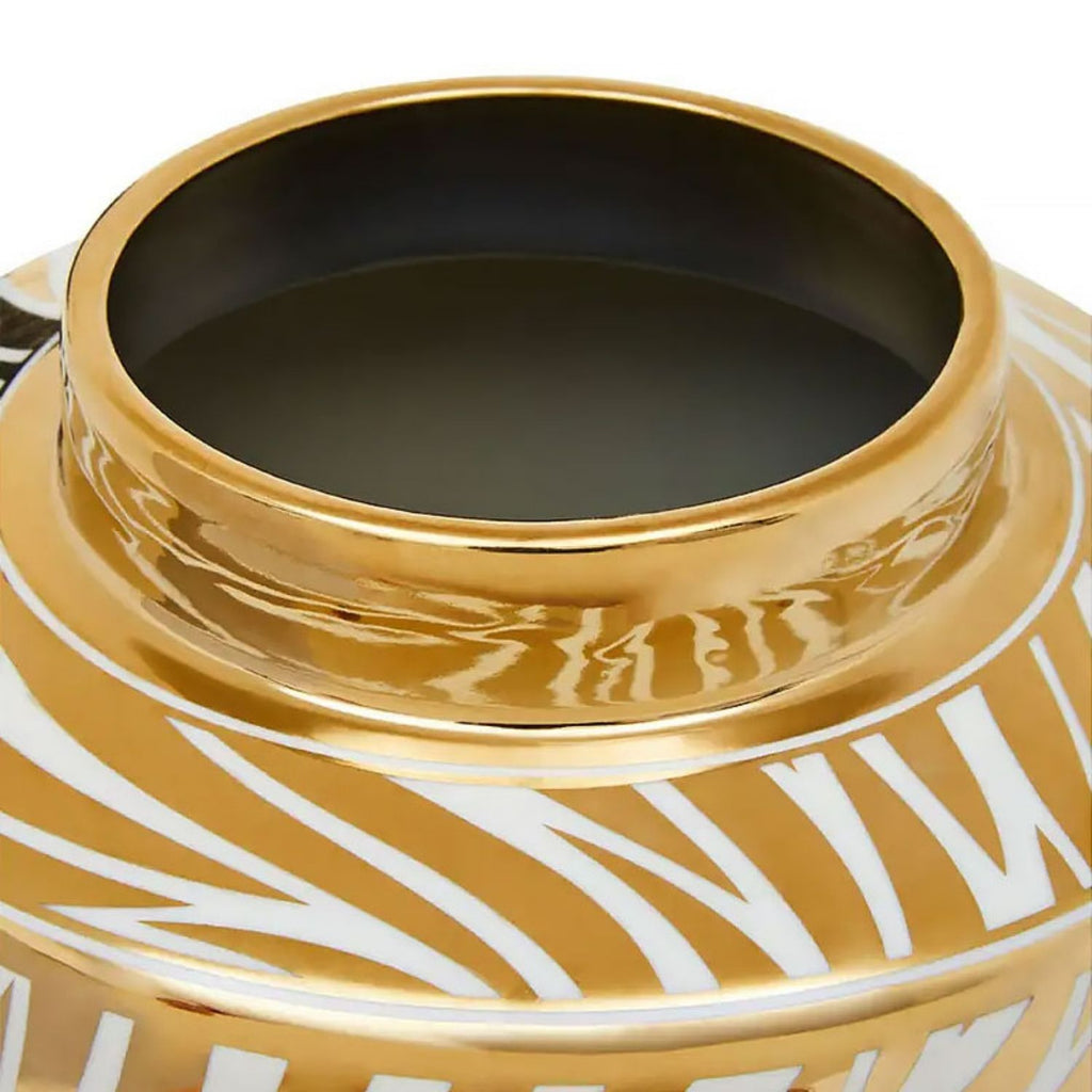 Close-up of a glossy gold ceramic vase with a white abstract leaf pattern and a dark interior, shown on a white background.