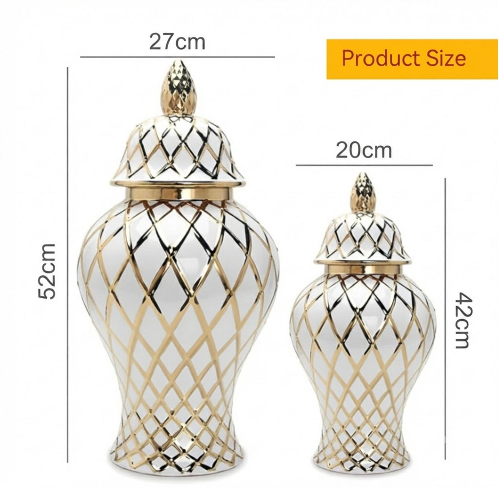 Two white ceramic decorative jars with gold geometric lattice patterns and matching lids, shown with dimension labels indicating 52cm height, 27cm top width, 20cm top width for the smaller jar, and 42cm height for the smaller jar.