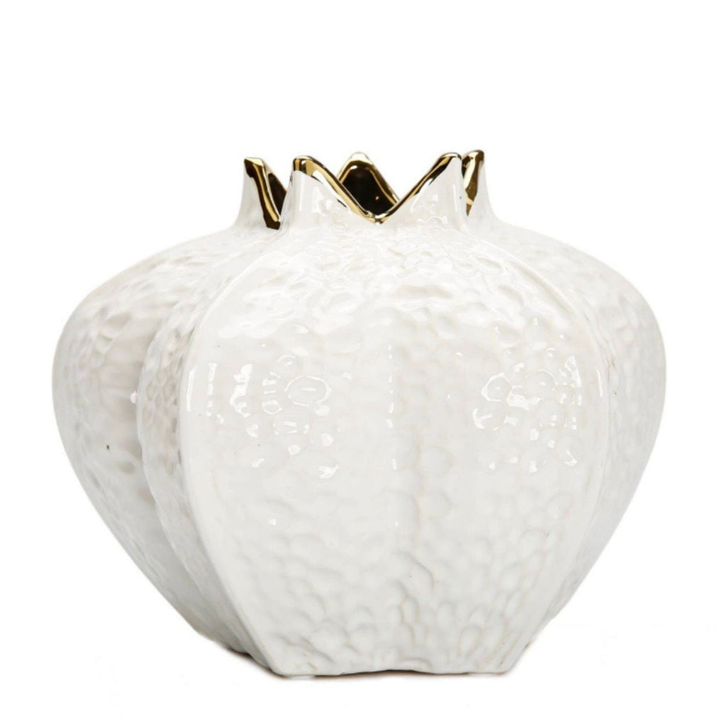 A white textured ceramic vase shaped like a pomegranate, featuring a glossy finish and gold trim along the fluted rim, set against a plain white background.
