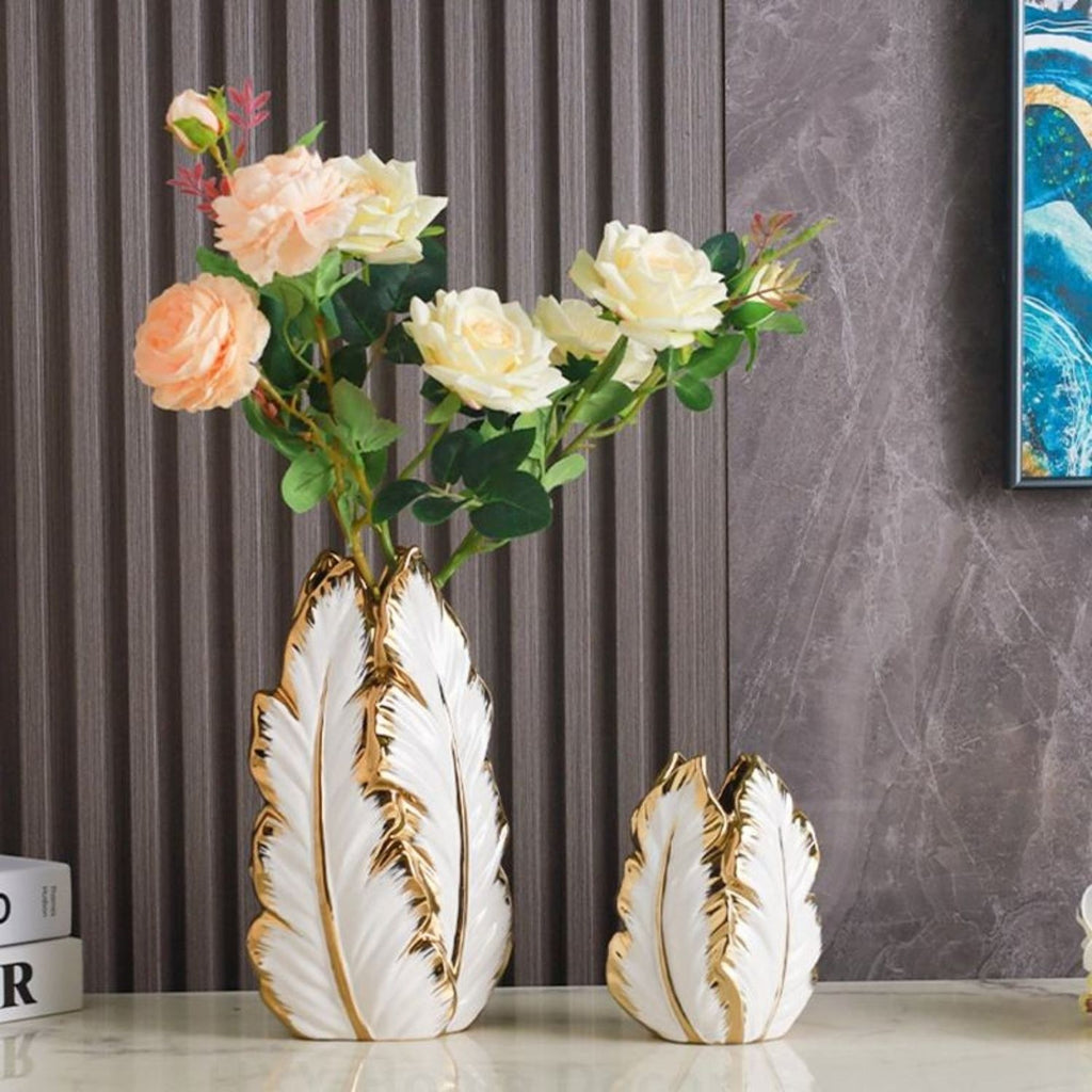 Decorative vases with floral arrangement against a gray curtain background