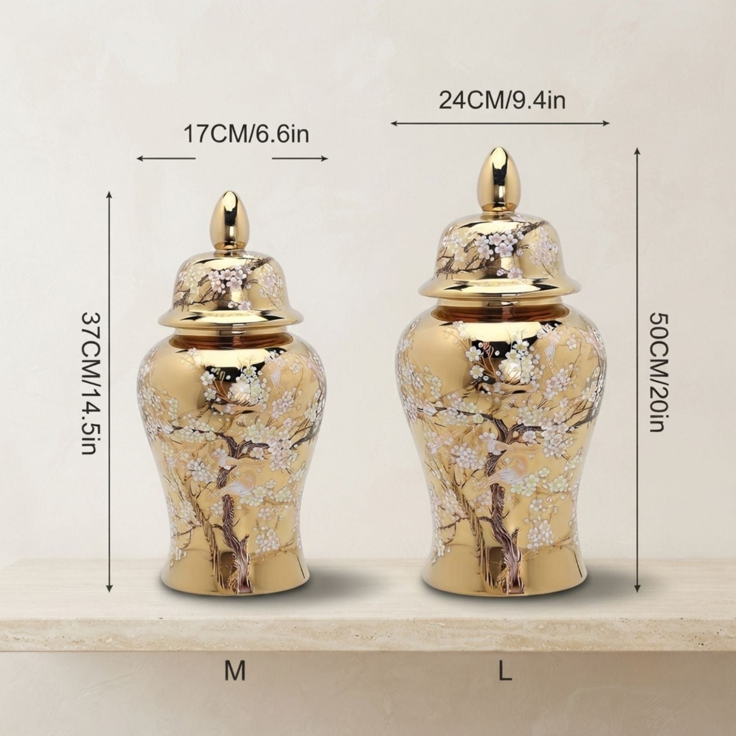 Two decorative gold-toned urns with floral painted detailing, shown on a light surface with overlaid size measurements labeled M and L.