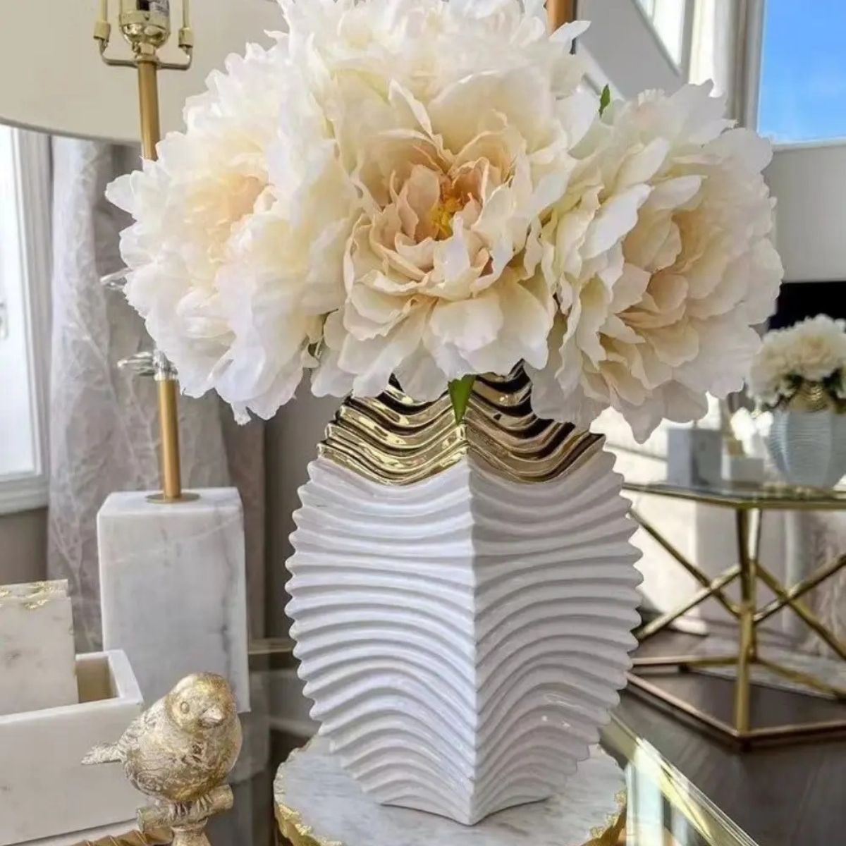 White and gold ceramic vase and star bowl styled together on shelf