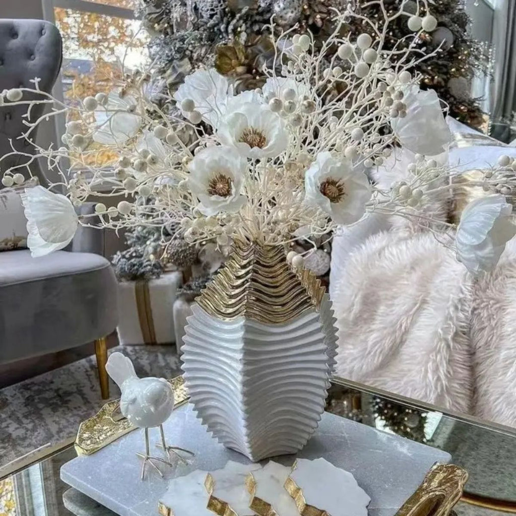 White and gold ceramic vase with peony flowers on glass coffee table