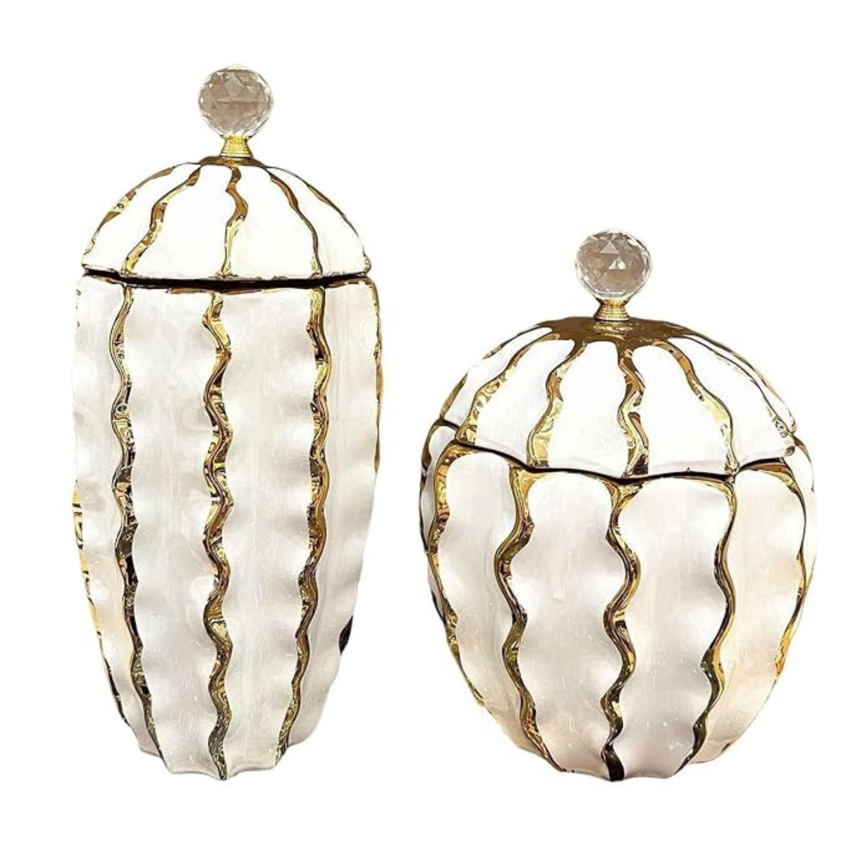 Set of two white and gold ribbed lidded vases on a white background