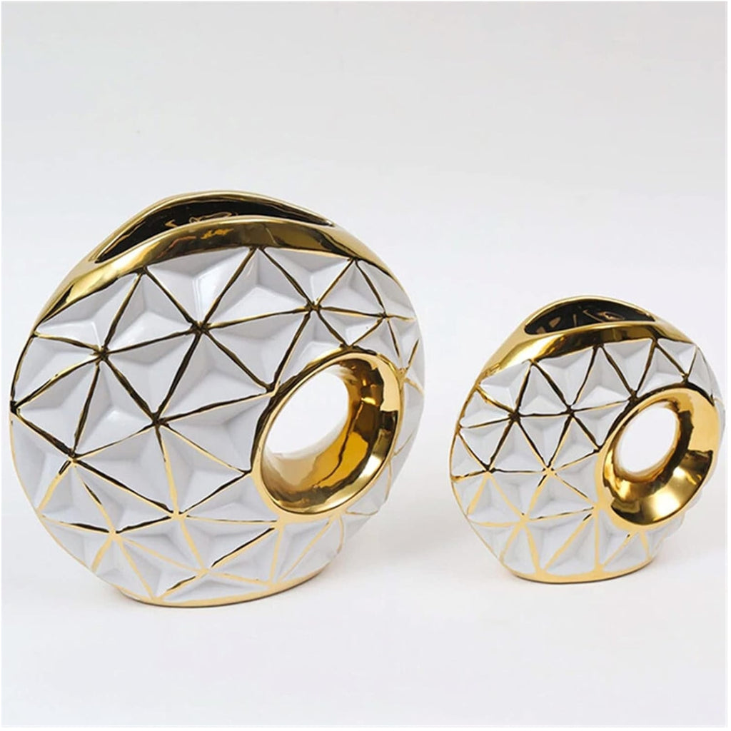 Small and large gold geometric vases in an elegant interior display
