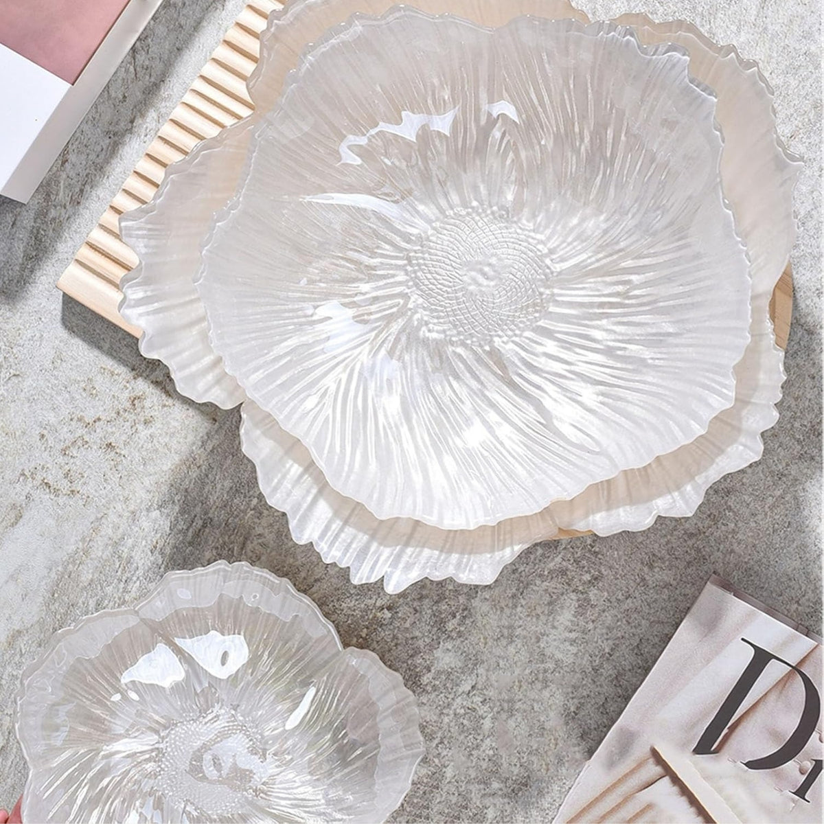 Overhead view of three translucent crystal glass fruit plates in different sizes