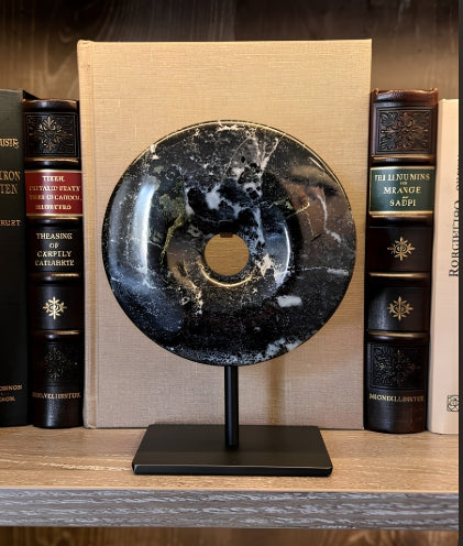 Toluca black marble disc sculpture on side table in living room