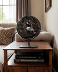 Toluca black marble disc sculpture on bookshelf